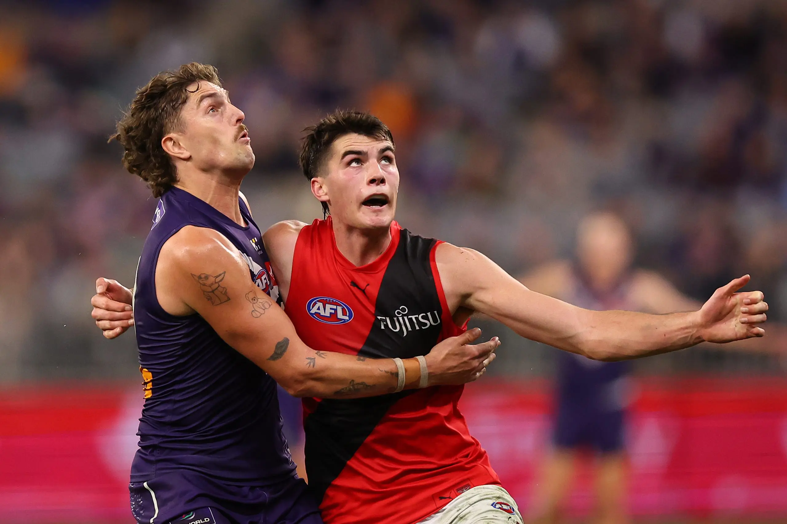 PERTH, AUSTRALIA - JUNE 19: Luke Jackson of the Dockers and Vigo Visentini of the Bombers contest the ruck during the round 15 AFL match between the Fremantle Dockers and Essendon Bombers at Optus Stadium, on June 19, 2025, in Perth, Australia. (Photo by Paul Kane/Getty Images)