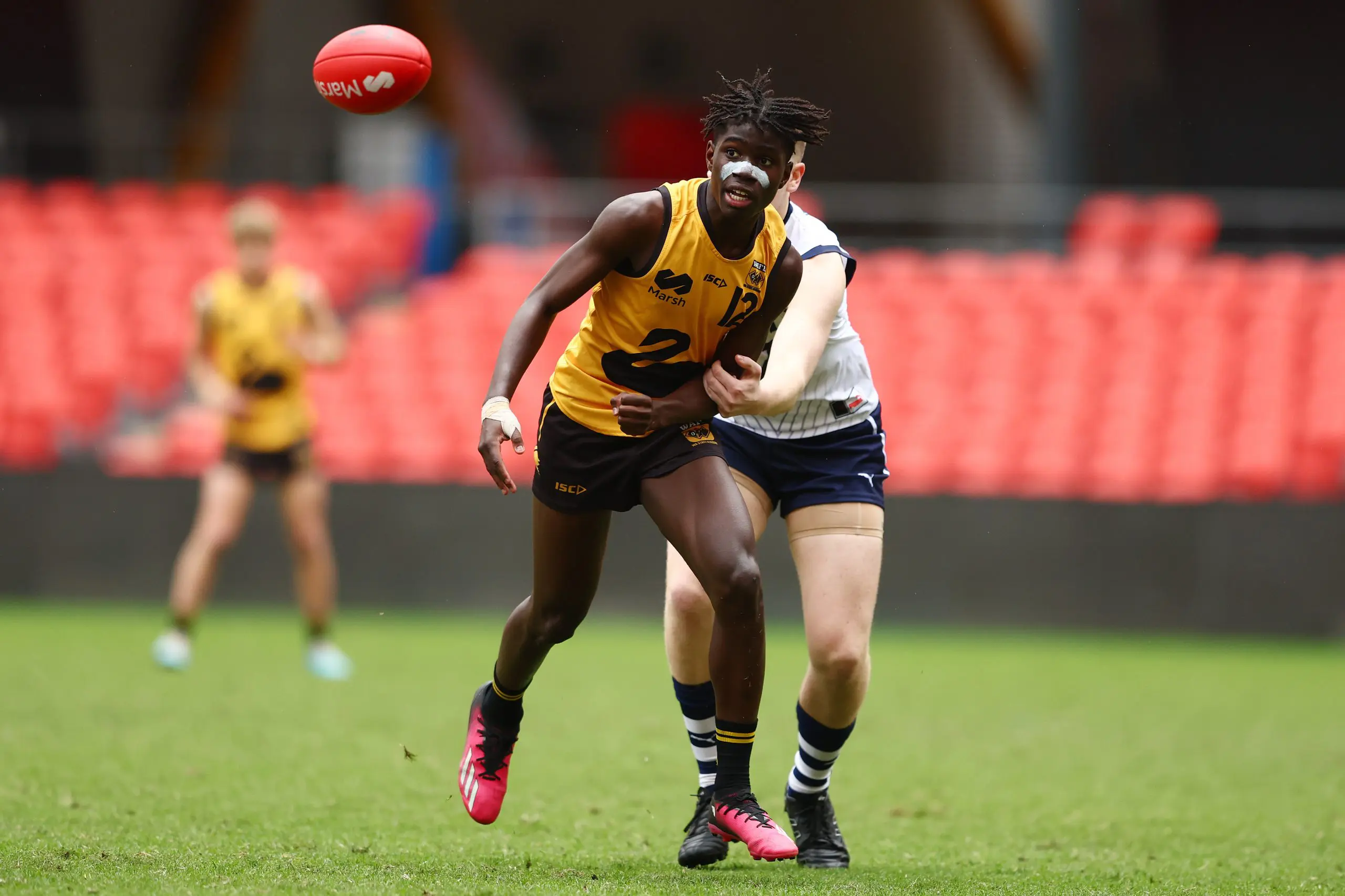 GOLD COAST, AUSTRALIA - JULY 09: Garrison Kenh of Western Australia handballs during the Marsh AFL National Championships match between U16 Boys Victoria Country and Western Australia at People First Stadium on July 09, 2024 in Gold Coast, Australia. (Photo by Chris Hyde/AFL Photos)