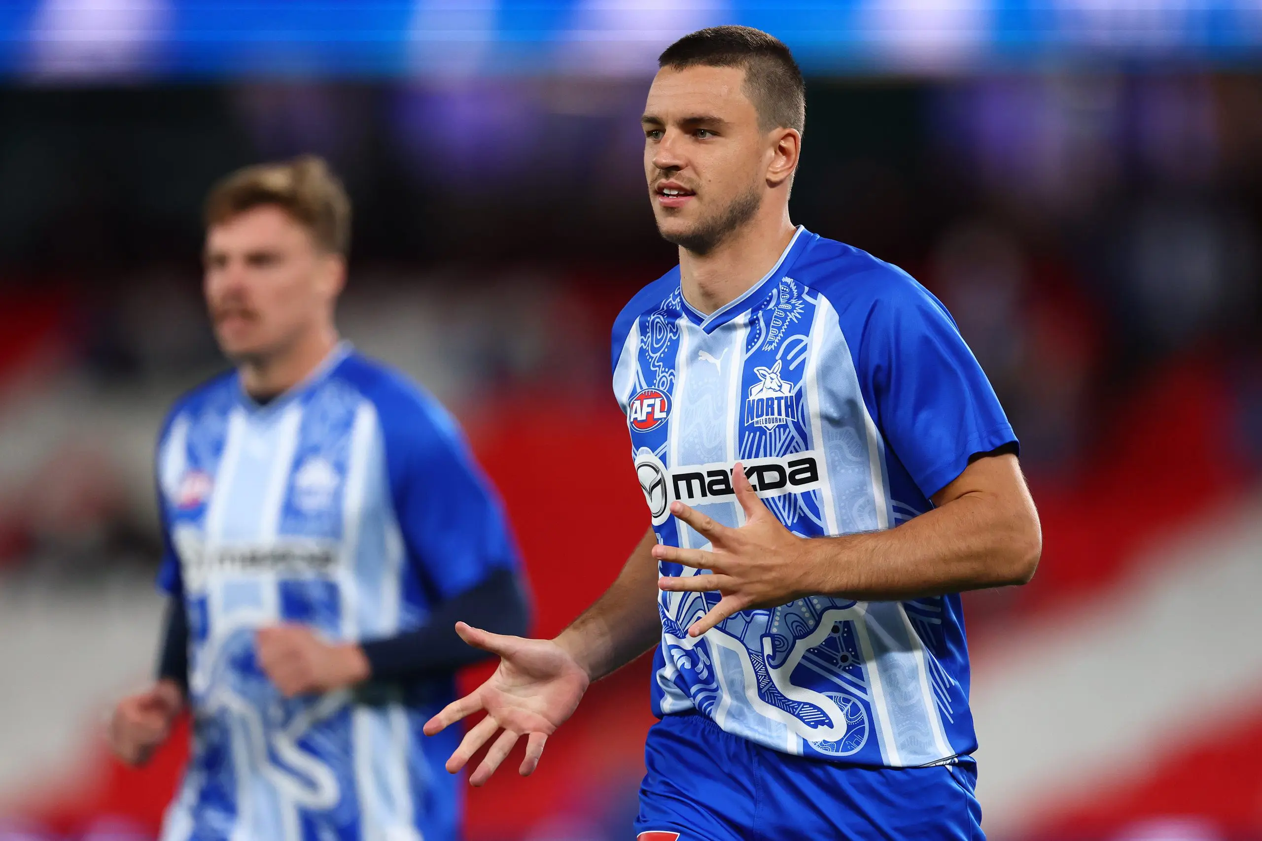MELBOURNE, AUSTRALIA - APRIL 05: Luke Davies-Uniacke of the Kangaroos warms up ahead of the round four AFL match between North Melbourne Kangaroos and Sydney Swans at Marvel Stadium, on April 05, 2025, in Melbourne, Australia. (Photo by Morgan Hancock/Getty Images)