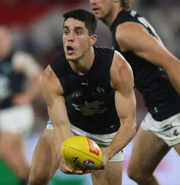 MELBOURNE, AUSTRALIA - APRIL 18: Adam Cerra of the Blues handballs during the round six AFL match between North Melbourne Kangaroos and Carlton Blues at Marvel Stadium, on April 18, 2025, in Melbourne, Australia. (Photo by Daniel Pockett/Getty Images)