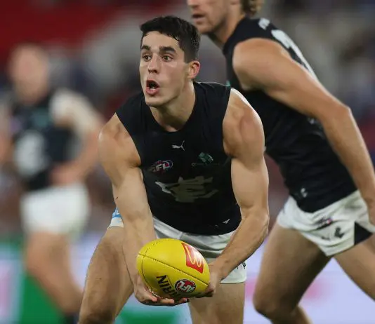 MELBOURNE, AUSTRALIA - APRIL 18: Adam Cerra of the Blues handballs during the round six AFL match between North Melbourne Kangaroos and Carlton Blues at Marvel Stadium, on April 18, 2025, in Melbourne, Australia. (Photo by Daniel Pockett/Getty Images)