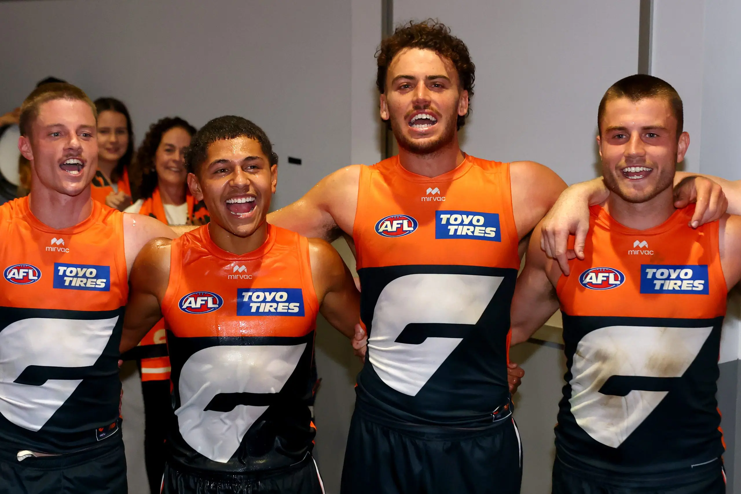 GEELONG, AUSTRALIA - MAY 11: Jacob Wehr, Josaia Delana, Jake Riccardi and Xavier O'Halloran of the Giants sing the song in the rooms after winning the round nine AFL match between Geelong Cats and GWS Giants at GMHBA Stadium, on May 11, 2025, in Geelong, Australia. (Photo by Josh Chadwick/Getty Images)
