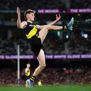MELBOURNE, AUSTRALIA - JULY 12: Luke Trainor of the Tigers kicks the ball during the round 18 AFL match between Richmond Tigers and Essendon Bombers at Melbourne Cricket Ground on July 12, 2025 in Melbourne, Australia. (Photo by Morgan Hancock/Getty Images via AFL Photos)
