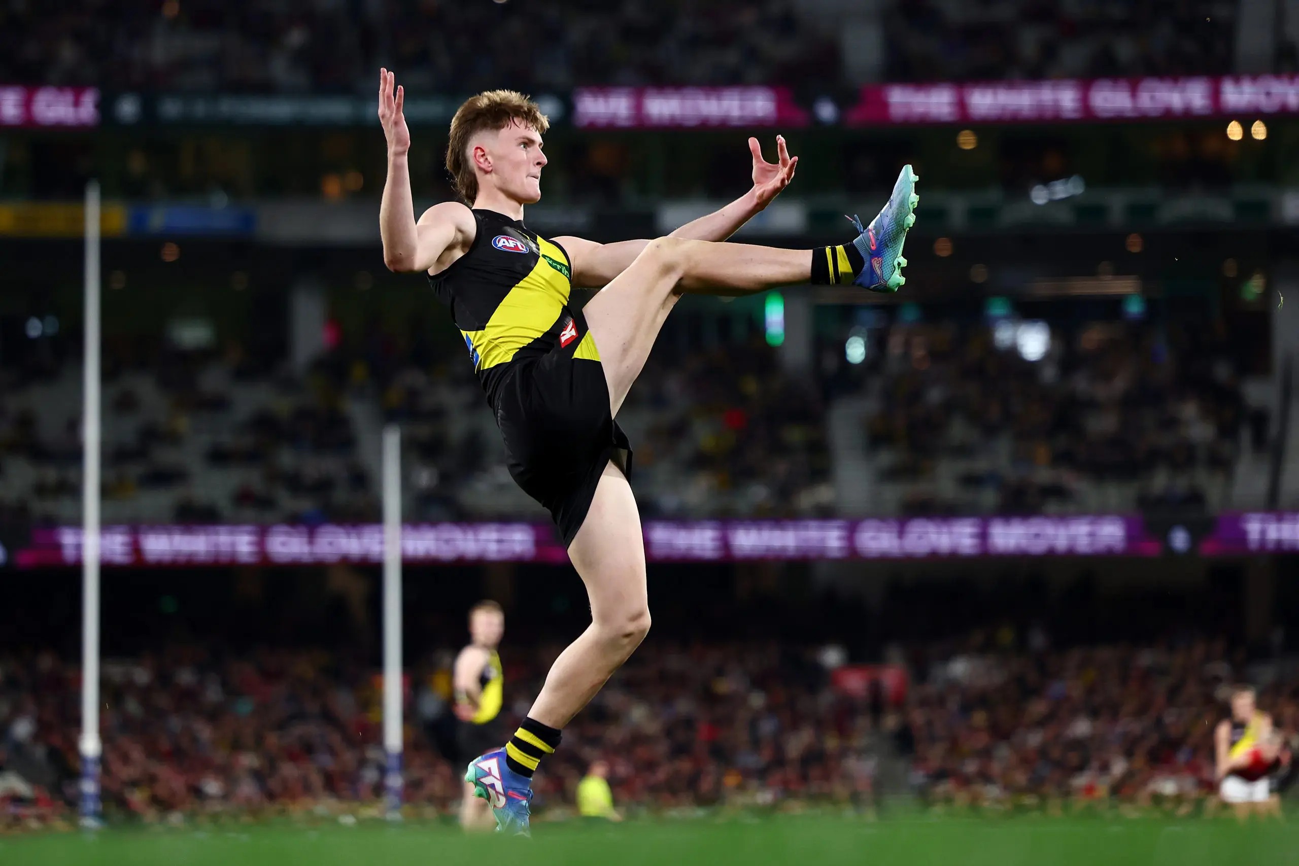MELBOURNE, AUSTRALIA - JULY 12: Luke Trainor of the Tigers kicks the ball during the round 18 AFL match between Richmond Tigers and Essendon Bombers at Melbourne Cricket Ground on July 12, 2025 in Melbourne, Australia. (Photo by Morgan Hancock/Getty Images via AFL Photos)