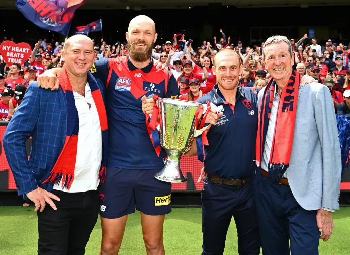MELBOURNE, AUSTRALIA - DECEMBER 05: David Neitz, Max Gawn, Simon Goodwin and Neale Daniher pose with the trophy during the Melbourne Demons AFL Premiership Celebration at Melbourne Cricket Ground on December 05, 2021 in Melbourne, Australia. (Photo by Quinn Rooney/Getty Images)