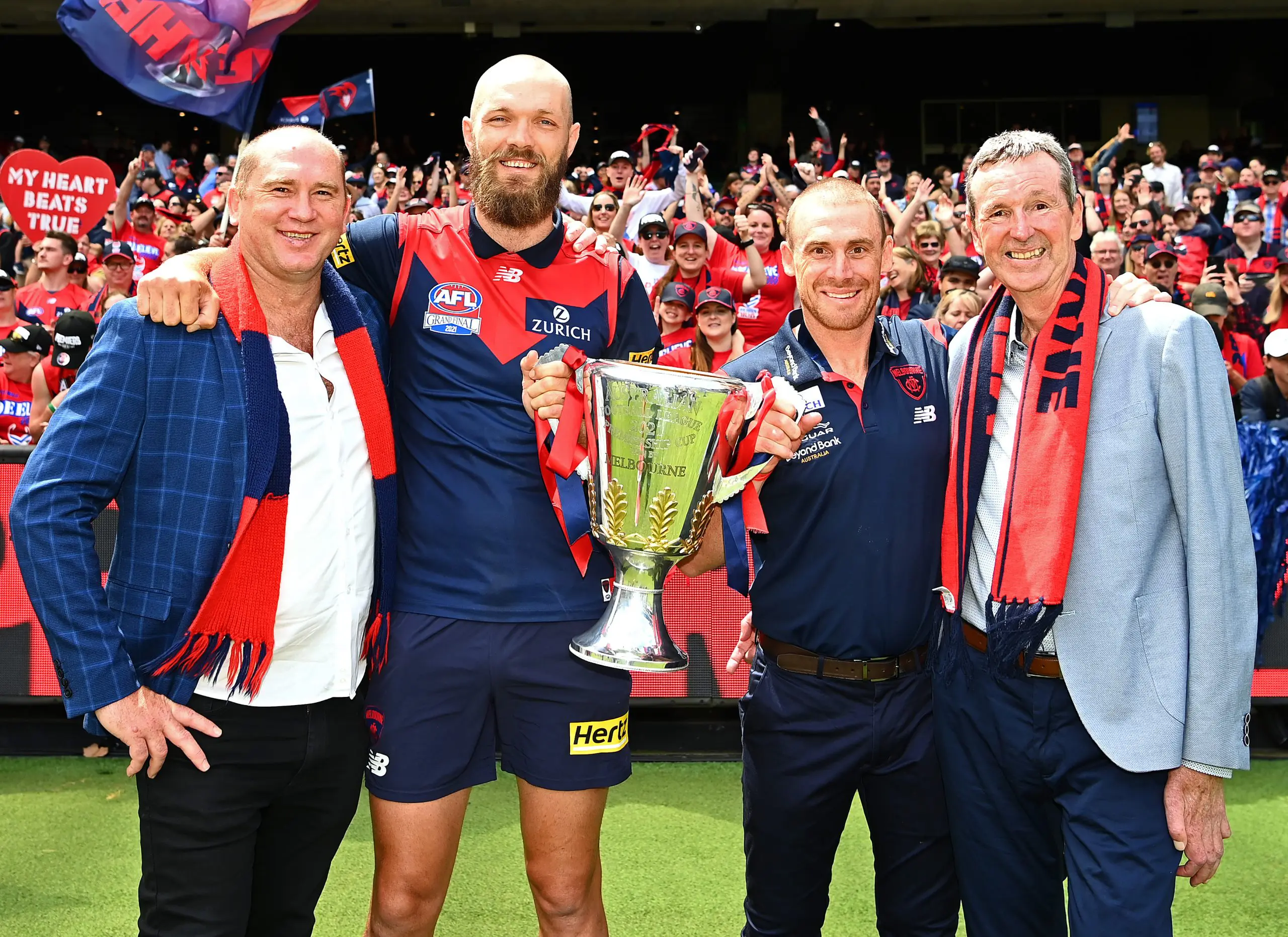 MELBOURNE, AUSTRALIA - DECEMBER 05: David Neitz, Max Gawn, Simon Goodwin and Neale Daniher pose with the trophy during the Melbourne Demons AFL Premiership Celebration at Melbourne Cricket Ground on December 05, 2021 in Melbourne, Australia. (Photo by Quinn Rooney/Getty Images)