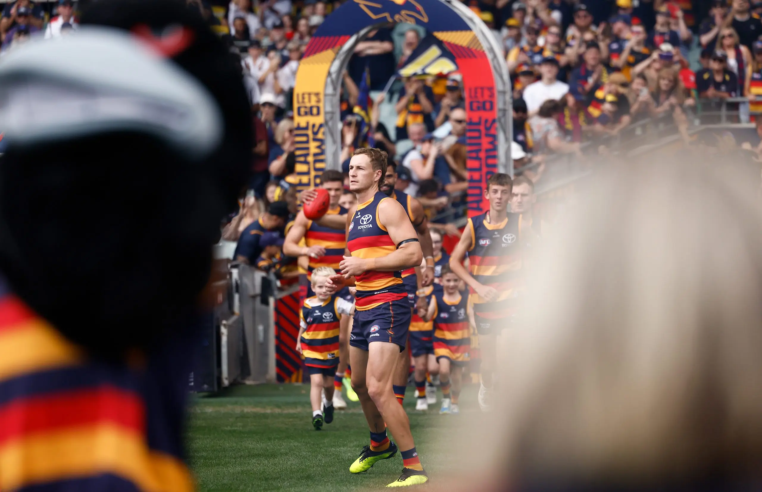 ADELAIDE, AUSTRALIA - MARCH 16: Jordan Dawson of the Crows runs onto the field during the 2025 AFL Round 01 match between the Adelaide Crows and the St Kilda Saints at Adelaide Oval on March 16, 2025 in Adelaide, Australia. (Photo by Michael Willson/AFL Photos via Getty Images)
