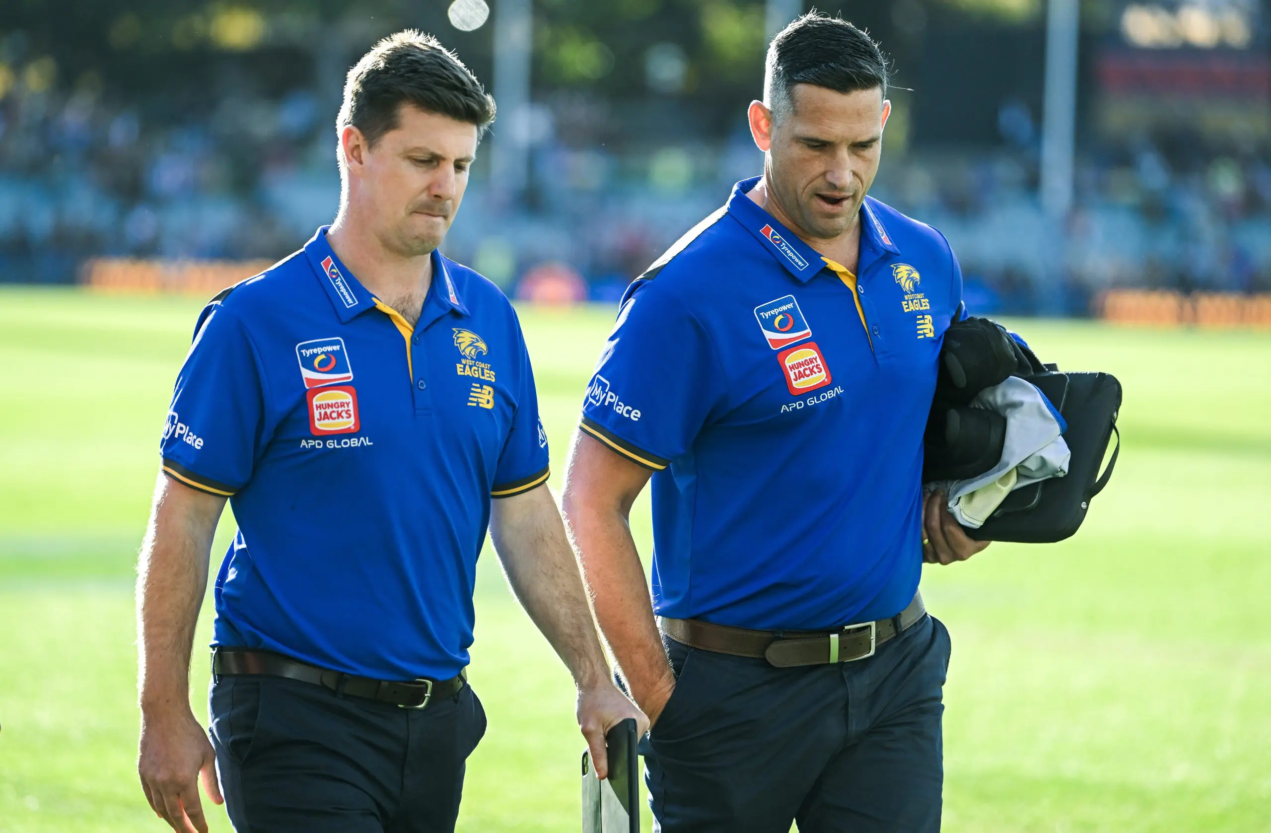 ADELAIDE, AUSTRALIA - MAY 25: Andrew McQualter head coach of the Eagles and assistant coach Luke Webster leave the ground after losing the round 11 AFL match between Kuwarna (Adelaide Crows) v Waalitj Marawar (West Coast Eagles) at Adelaide Oval, on May 25, 2025, in Adelaide, Australia. (Photo by Mark Brake/Getty Images)