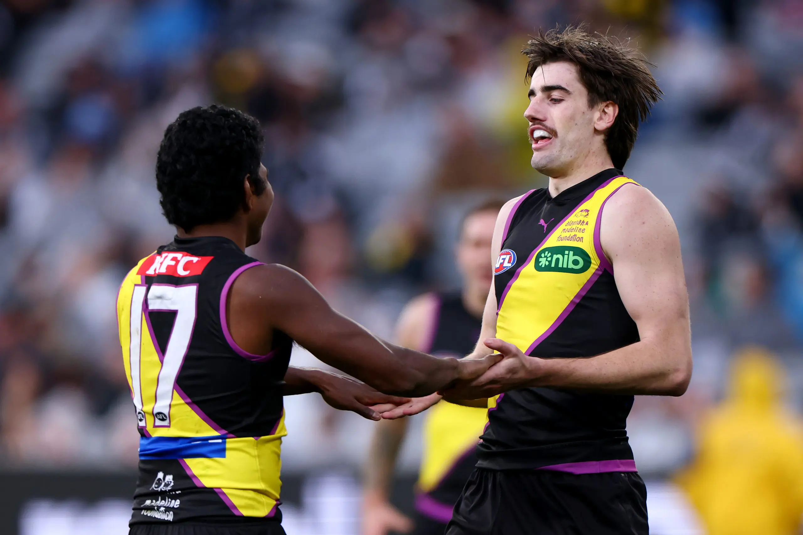 MELBOURNE, AUSTRALIA - JULY 27: Jonty Faull of the Tigers is congratulated by Maurice Rioli after kicking a goal during the round 20 AFL match between Richmond Tigers and Collingwood Magpies at Melbourne Cricket Ground on July 27, 2025 in Melbourne, Australia. (Photo by Daniel Pockett/Getty Images)