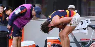 PERTH, AUSTRALIA - AUGUST 10: The Crows physio checks on Riley Thilthorpe of the Crows after coming from the field during the round 22 AFL match between West Coast Eagles and Adelaide Crows at Optus Stadium on August 10, 2025 in Perth, Australia. (Photo by Paul Kane/Getty Images)