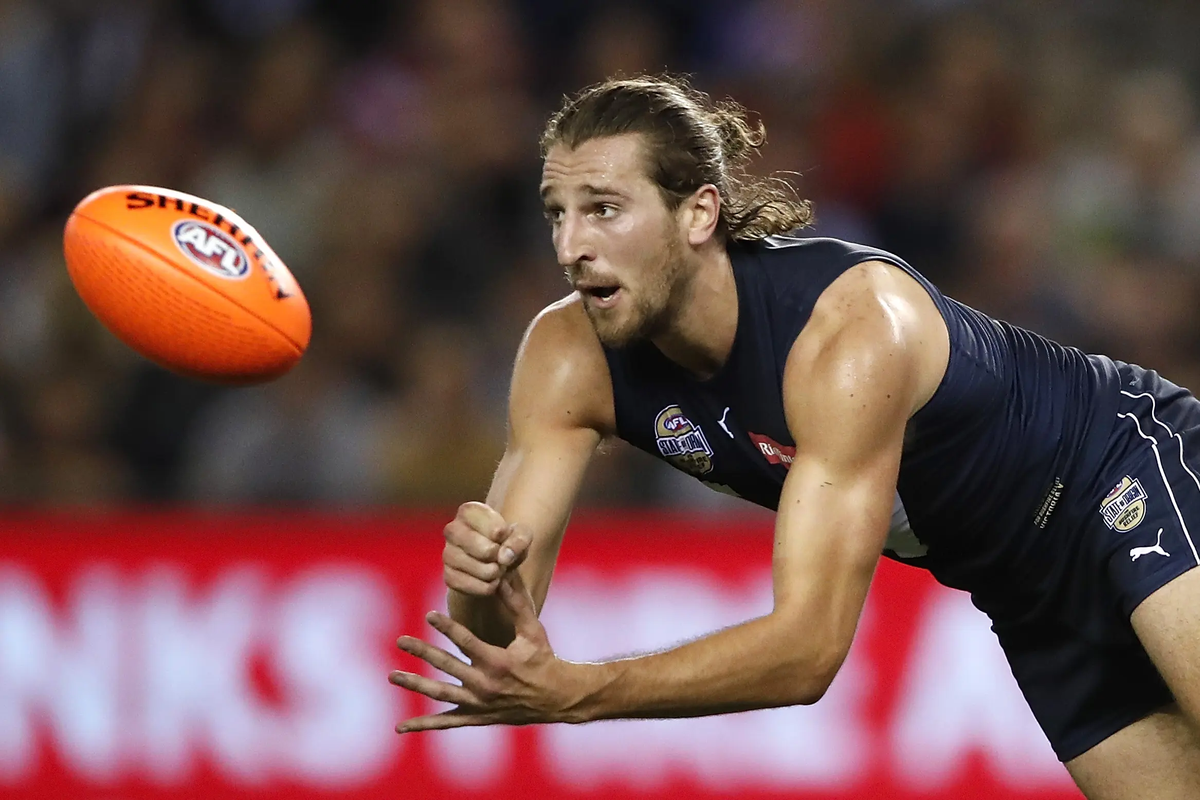 MELBOURNE, AUSTRALIA - FEBRUARY 28: Marcus Bontempelli of Victoria handpasses the ball during the 2020 State of Origin for Bushfire Relief match between Victoria and the All Stars at Marvel Stadium on February 28, 2020 in Melbourne, Australia. (Photo by Dylan Burns/AFL Photos via Getty Images)