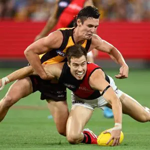MELBOURNE, AUSTRALIA - MARCH 14: Zach Merrett of the Bombers is tackled by Connor Macdonald of the Hawks during the round one AFL match between Hawthorn Hawks and Essendon Bombers at Melbourne Cricket Ground, on March 14, 2025, in Melbourne, Australia. (Photo by Quinn Rooney/Getty Images)