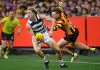 MELBOURNE, AUSTRALIA - APRIL 21: Zach Guthrie of the Cats is tackled by James Sicily of the Hawks  during the round six AFL match between Geelong Cats and Hawthorn Hawks at Melbourne Cricket Ground, on April 21, 2025, in Melbourne, Australia. (Photo by Quinn Rooney/Getty Images)