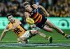 ADELAIDE, AUSTRALIA - AUGUST 01: Mitchell Hinge of the Crows handballs over Conor Nash of the Hawks during the round 21 AFL match between Adelaide Crows and Hawthorn Hawks at Adelaide Oval on August 01, 2025 in Adelaide, Australia. (Photo by Mark Brake/Getty Images)