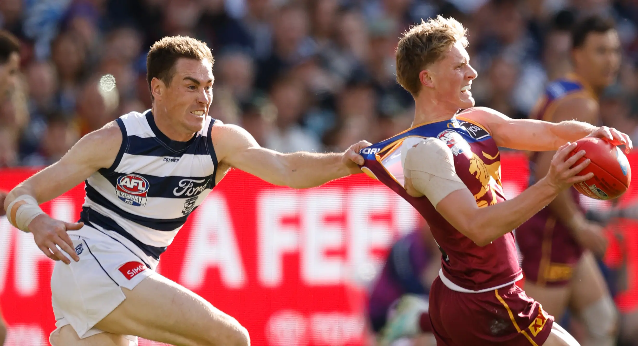 MELBOURNE, AUSTRALIA - SEPTEMBER 27: Jaspa Fletcher of the Lions is tackled by Jeremy Cameron of the Cats during the AFL Grand Final match between the Geelong Cats and the Brisbane Lions at the Melbourne Cricket Ground on September 27, 2025 in Melbourne, Australia. (Photo by Michael Willson/AFL Photos via Getty Images)