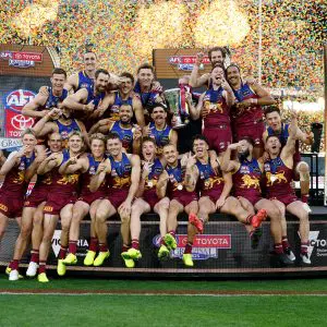 MELBOURNE, AUSTRALIA - SEPTEMBER 27: The Lions celebrate on the dais after winning the AFL Grand Final match between the Geelong Cats and the Brisbane Lions at the Melbourne Cricket Ground on September 27, 2025 in Melbourne, Australia. (Photo by Michael Willson/AFL Photos via Getty Images)