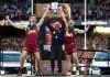 MELBOURNE, AUSTRALIA - SEPTEMBER 27: Harris Andrews of the Lions, Chris Fagan, Senior Coach of the Lions and Lachie Neale of the Lions celebrate with the Premiership Cup on the dais during the AFL Grand Final match between the Geelong Cats and the Brisbane Lions at the Melbourne Cricket Ground on September 27, 2025 in Melbourne, Australia. (Photo by Michael Willson/AFL Photos via Getty Images)