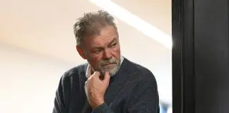 MELBOURNE, AUSTRALIA - MAY 23: Richmond senior club advisor Neil Balme listens at the door way as Damien Hardwick the coach of the Tigers speaks to the media during a Richmond Tigers AFL press conference at Punt Road Oval on May 23, 2023 in Melbourne, Australia. (Photo by Quinn Rooney/Getty Images)