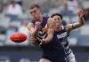 GEELONG, AUSTRALIA - MARCH 15: Liam Reidy of the Dockers handballs under pressure from Jack Henry of the Cats during the round one AFL match between Geelong Cats and Fremantle Dockers at GMHBA Stadium, on March 15, 2025, in Geelong, Australia. (Photo by Daniel Pockett/Getty Images)