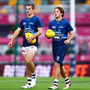BRISBANE, AUSTRALIA - MARCH 29: Ted Clohesy and Jhye Clark of the Cats are seen prior to the 2025 AFL Round 03 match between the Brisbane Lions and the Geelong Cats at The Gabba on March 29, 2025 in Brisbane, Australia. (Photo by Russell Freeman/AFL Photos via Getty Images)