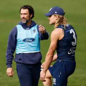 GEELONG, AUSTRALIA - MAY 15: Chris Scott, Senior Coach of the Cats and Bailey Smith of the Cats chat during the Geelong Cats training session at GMHBA Stadium on May 15, 2025 in Geelong, Australia. (Photo by Michael Willson/AFL Photos via Getty Images)