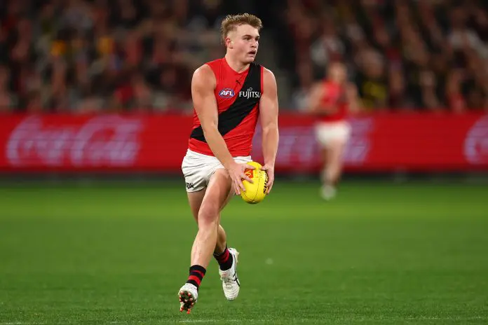 MELBOURNE, AUSTRALIA - JULY 12: Oskar Smartt of the Bombers runs with the ball during the round 18 AFL match between Richmond Tigers and Essendon Bombers at Melbourne Cricket Ground on July 12, 2025 in Melbourne, Australia. (Photo by Morgan Hancock/Getty Images)