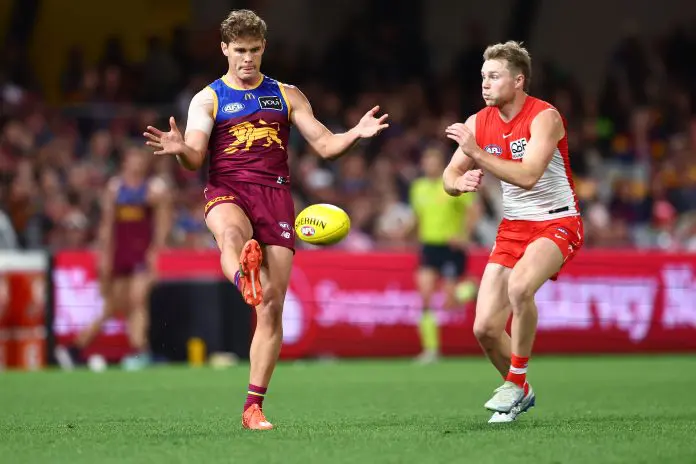 BRISBANE, AUSTRALIA - AUGUST 09: Deven Robertson of the Lions kicks during the round 22 AFL match between Brisbane Lions and Sydney Swans at The Gabba on August 09, 2025 in Brisbane, Australia. (Photo by Chris Hyde/AFL Photos/via Getty Images)