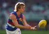 MELBOURNE, AUSTRALIA - AUGUST 10: Ryley Sanders of the Bulldogs handballs during the round 22 AFL match between Melbourne Demons and Western Bulldogs at Melbourne Cricket Ground on August 10, 2025 in Melbourne, Australia. (Photo by Morgan Hancock/Getty Images)