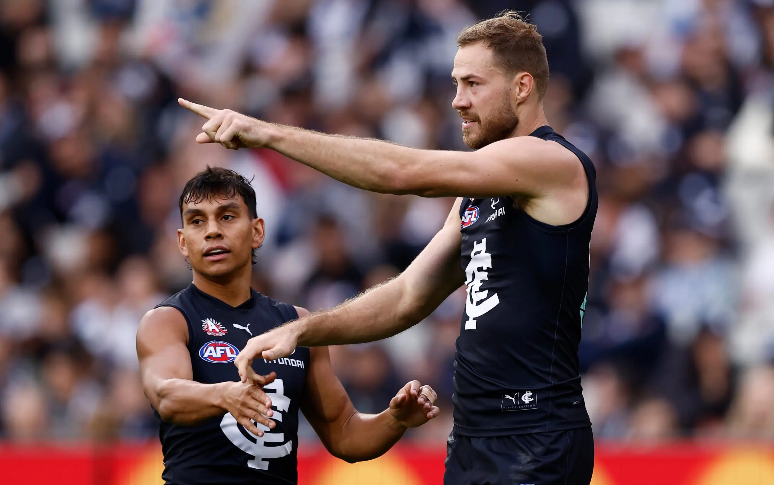 MELBOURNE, AUSTRALIA - APRIL 27: Jesse Motlop (left) and Harry McKay of the Blues celebrate during the 2025 AFL Round 07 match between the Carlton Blues and the Geelong Cats at the Melbourne Cricket Ground on April 27, 2025 in Melbourne, Australia. (Photo by Michael Willson/AFL Photos via Getty Images)