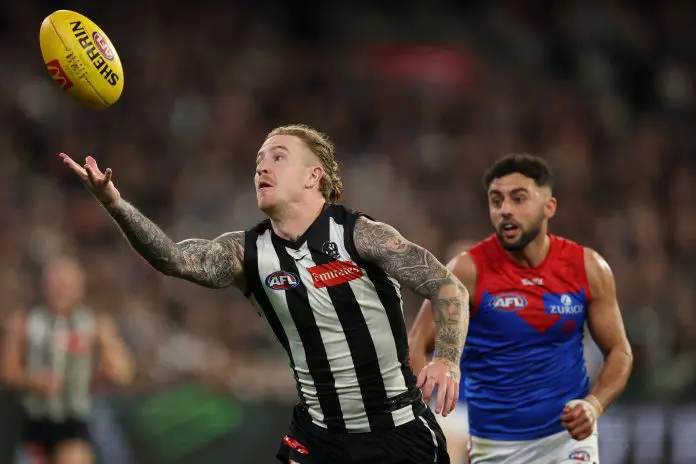 MELBOURNE, AUSTRALIA - AUGUST 22: Beau McCreery of the Magpies gathers the ball during the round 24 AFL match between Collingwood Magpies and Melbourne Demons at Melbourne Cricket Ground on August 22, 2025 in Melbourne, Australia. (Photo by Robert Cianflone/Getty Images)
