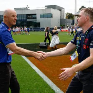MELBOURNE, AUSTRALIA - NOVEMBER 22: Darren Crocker, Senior Coach of the Kangaroos and Mick Stinear, Senior Coach of the Demons shake hands during the 2025 AFLW First Preliminary Final match between the North Melbourne Tasmanian Kangaroos and the Melbourne Demons at Ikon Park on November 22, 2025 in Melbourne, Australia. (Photo by Michael Willson/AFL Photos via Getty Images)
