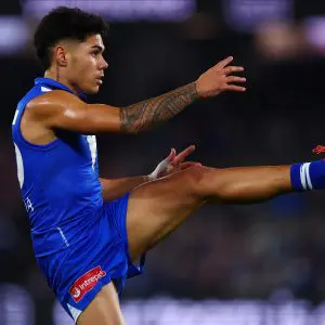 MELBOURNE, AUSTRALIA - JULY 03: Paul Curtis of the Kangaroos kicks the ball during the round 17 AFL match between North Melbourne Kangaroos and Western Bulldogs at Marvel Stadium on July 03, 2025 in Melbourne, Australia. (Photo by Morgan Hancock/Getty Images)
