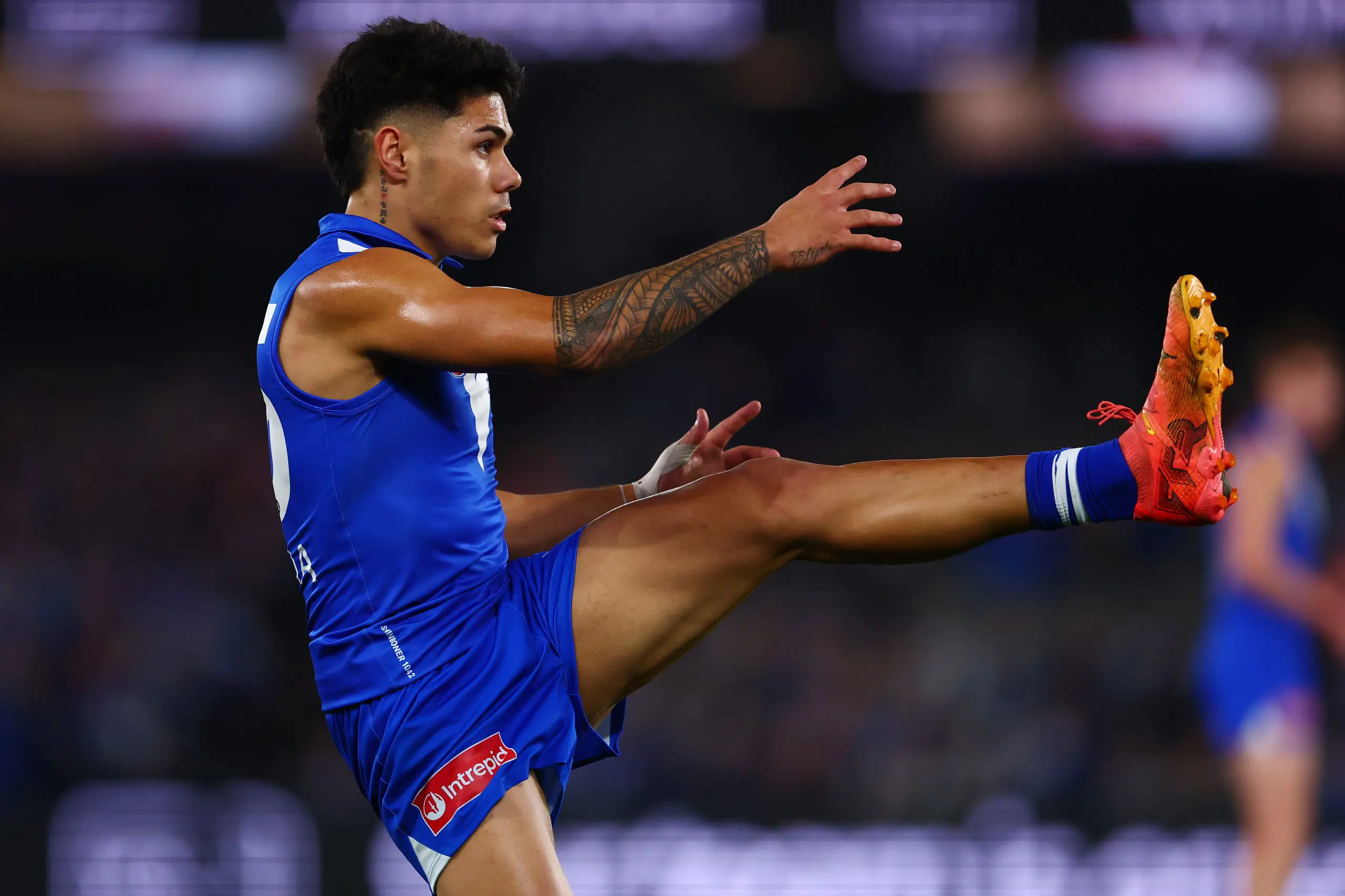 MELBOURNE, AUSTRALIA - JULY 03: Paul Curtis of the Kangaroos kicks the ball during the round 17 AFL match between North Melbourne Kangaroos and Western Bulldogs at Marvel Stadium on July 03, 2025 in Melbourne, Australia. (Photo by Morgan Hancock/Getty Images)