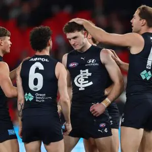 MELBOURNE, AUSTRALIA - AUGUST 16: Cooper Lord of the Blues, Hudson O'Keeffe of the Blues and Harry McKay of the Blues celebrate a goal during the round 23 AFL match between Carlton Blues and Port Adelaide Power at Marvel Stadium on August 16, 2025 in Melbourne, Australia. (Photo by Morgan Hancock/Getty Images)