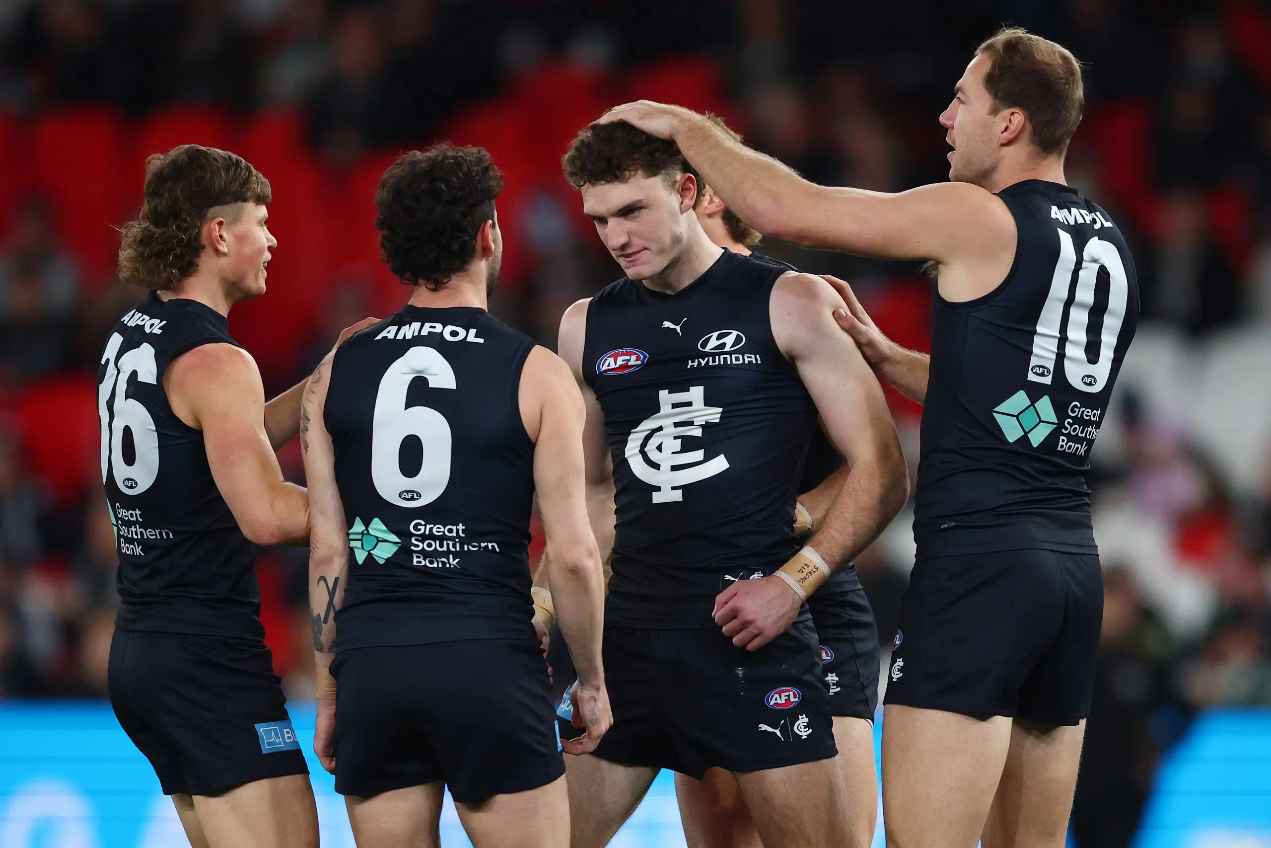 MELBOURNE, AUSTRALIA - AUGUST 16: Cooper Lord of the Blues, Hudson O'Keeffe of the Blues and Harry McKay of the Blues celebrate a goal during the round 23 AFL match between Carlton Blues and Port Adelaide Power at Marvel Stadium on August 16, 2025 in Melbourne, Australia. (Photo by Morgan Hancock/Getty Images)