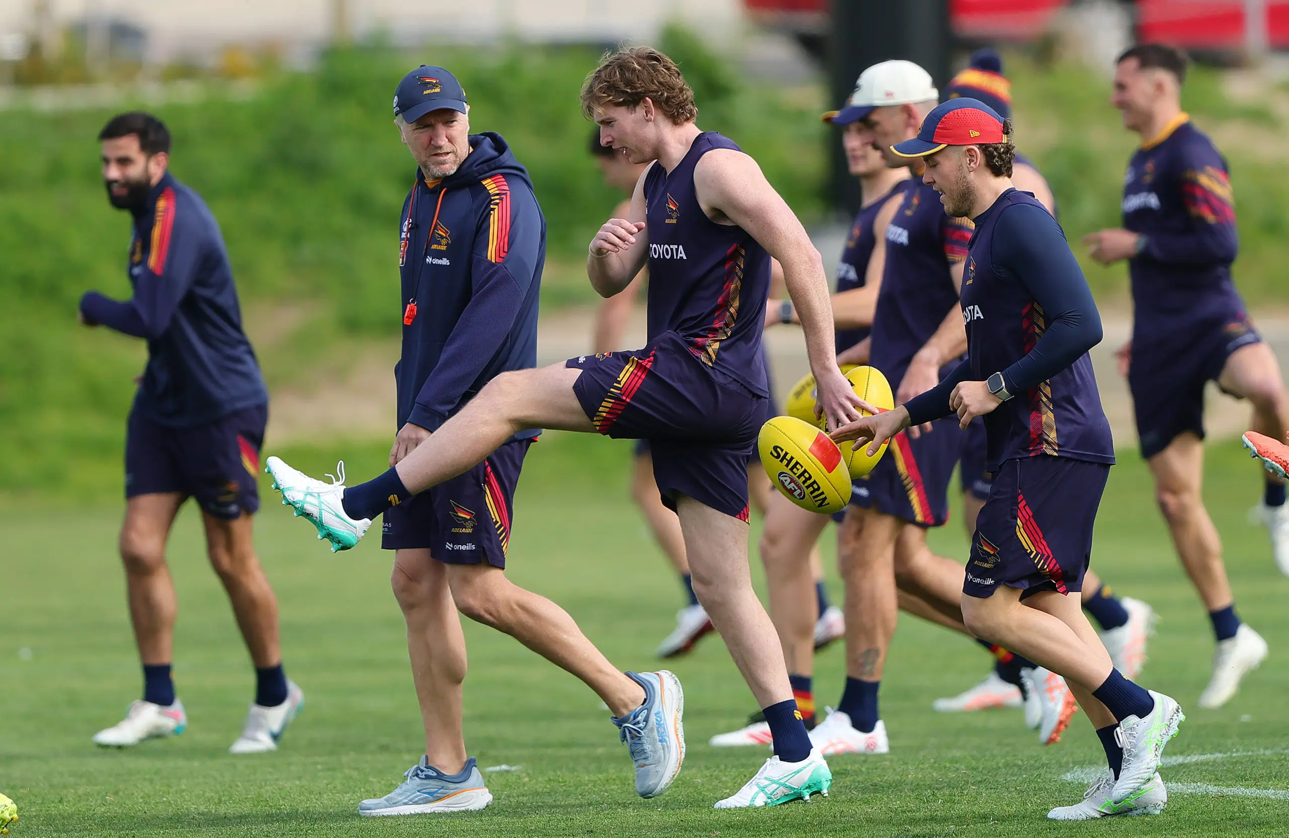 ADELAIDE, AUSTRALIA - SEPTEMBER 03: Head of Fitness Darren Burgess talks to Max Michalanney of the Crows during an Adelaide Crows AFL captain's run at West Lakes on September 03, 2025 in Adelaide, Australia. (Photo by Sarah Reed/Getty Images)