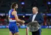 MELBOURNE, AUSTRALIA - APRIL 20: Marcus Bontempelli of the Bulldogs is presented with the Barker-Whitten Challenge plate by Ted Whitten Jnr during the 2025 AFL Round 06 match between the Western Bulldogs and the St Kilda Saints at Marvel Stadium on April 20, 2025 in Melbourne, Australia. (Photo by Michael Willson/AFL Photos via Getty Images)
