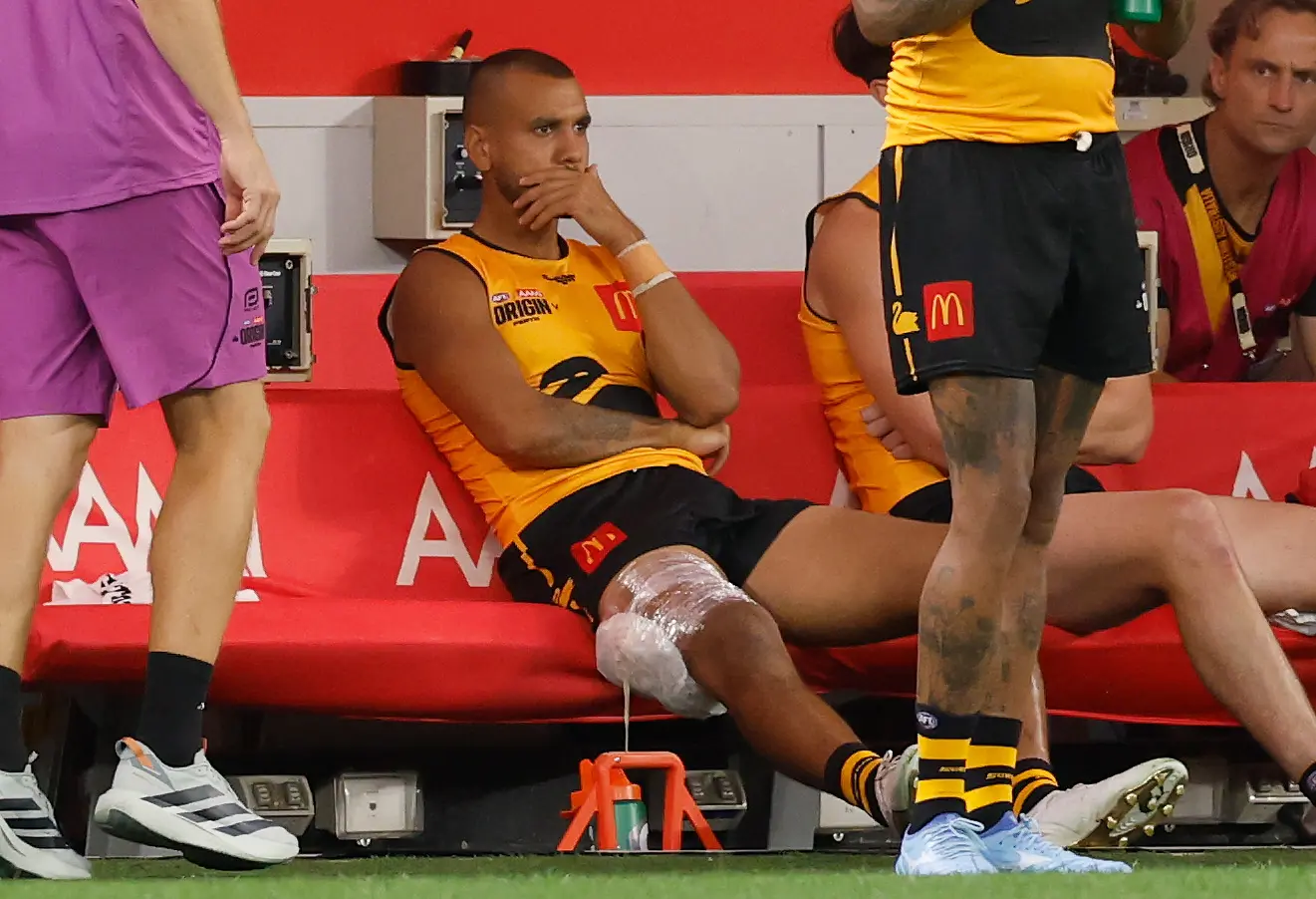 PERTH, AUSTRALIA - FEBRUARY 14: Callum Ah Chee of Western Australia looks on from the bench with ice on his hamstring during the 2026 AFL Origin match between Western Australia and Victoria at Optus Stadium on February 14, 2026 in Perth, Australia. (Photo by Michael Willson/AFL Photos via Getty Images)