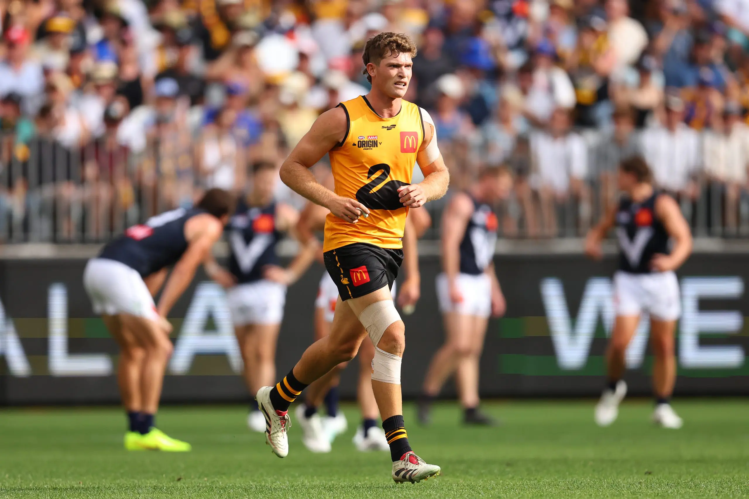 PERTH, AUSTRALIA - FEBRUARY 14: Mitch Georgiades of Western Australia jogs from the field after landing on Jacob Weitering of Victoria during the 2026 AFL Origin match between Western Australia and Victoria at Optus Stadium on February 14, 2026 in Perth, Australia. (Photo by Paul Kane/Getty Images)