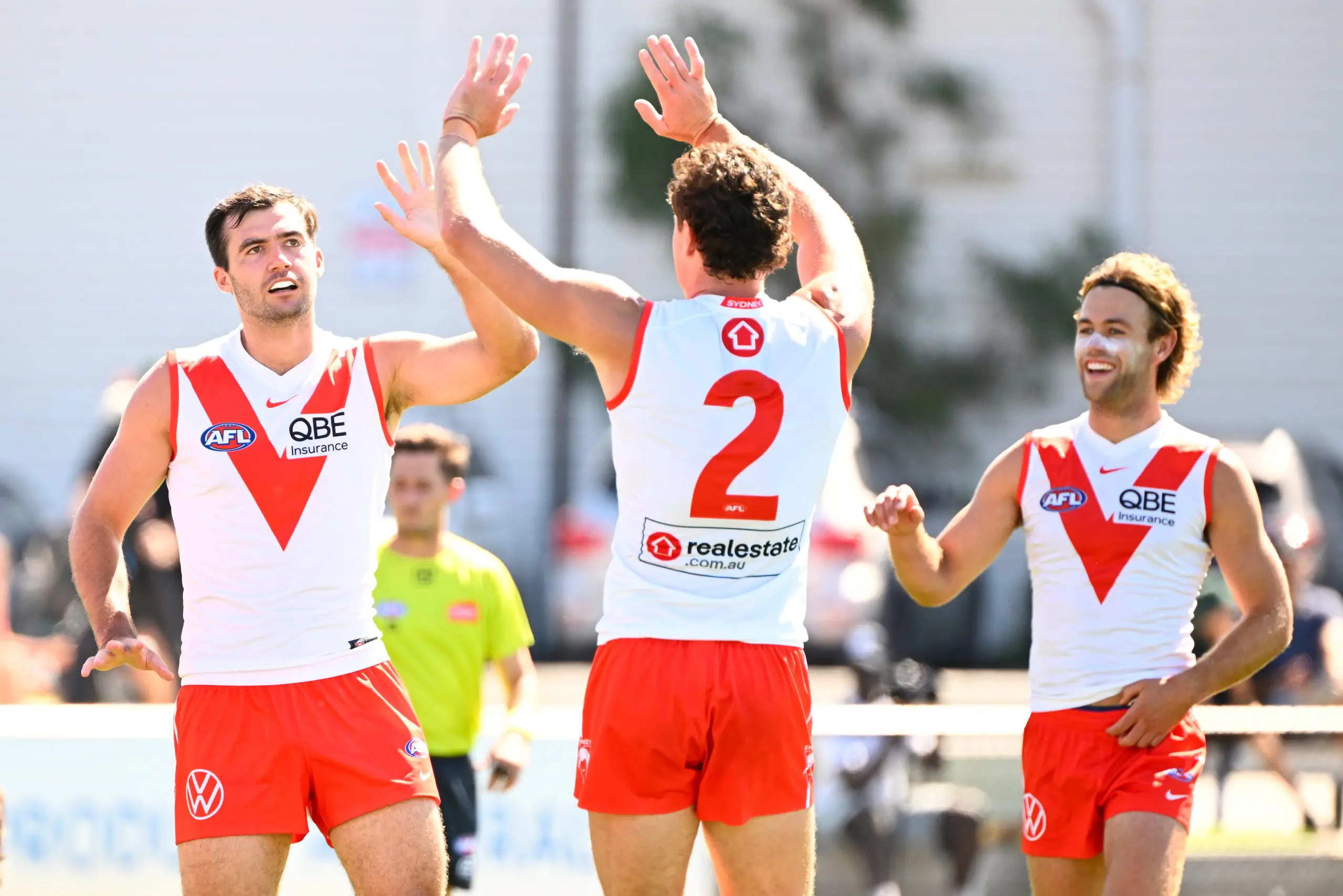 MELBOURNE, AUSTRALIA - FEBRUARY 19: Logan McDonald of the Swans (left) celebrates a goal with Hayden McLean and James Rowbottom of the Swans during the 2026 AFL match simulation between the Western Bulldogs and the Sydney Swans at Mission Whitten Oval on February 19, 2026 in Melbourne, Australia. (Photo by Adam Trafford/AFL Photos via Getty Images)