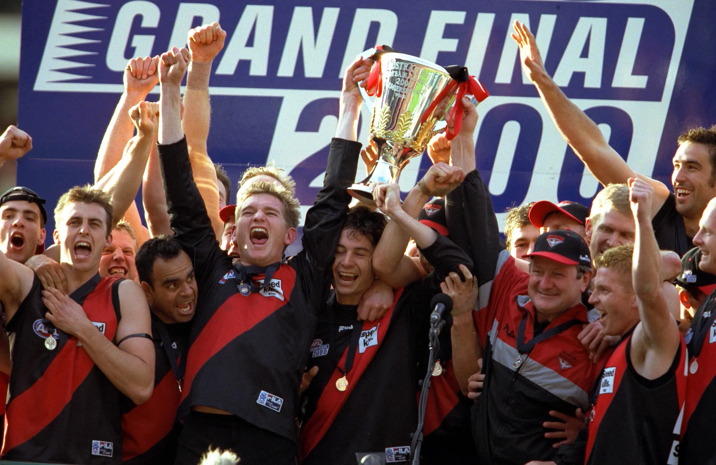 2 Sep 2000: Essendon players celebrate on the podium with the Premiership Cup after their win, in the AFL Grand Final match between the Essendon Bombers and the Melbourne Demons, played at the Melbourne Cricket Ground in Melbourne, Australia. Mandatory Credit: Darrin Braybrook/ALLSPORT