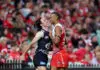SYDNEY, AUSTRALIA - MAY 16: Oliver Hollands of the Blues and Joel Amartey of the Swans exchange wordduring the round ten AFL match between Sydney Swans and Carlton Blues at Sydney Cricket Ground, on May 16, 2025, in Sydney, Australia. (Photo by Cameron Spencer/Getty Images)
