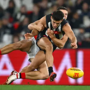 MELBOURNE, AUSTRALIA - JUNE 21: Marcus Windhager of the Saints tackles Nick Daicos of the Magpies during the round 15 AFL match between Collingwood Magpies and St Kilda Saints at Marvel Stadium, on June 21, 2025, in Melbourne, Australia. (Photo by Quinn Rooney/Getty Images)