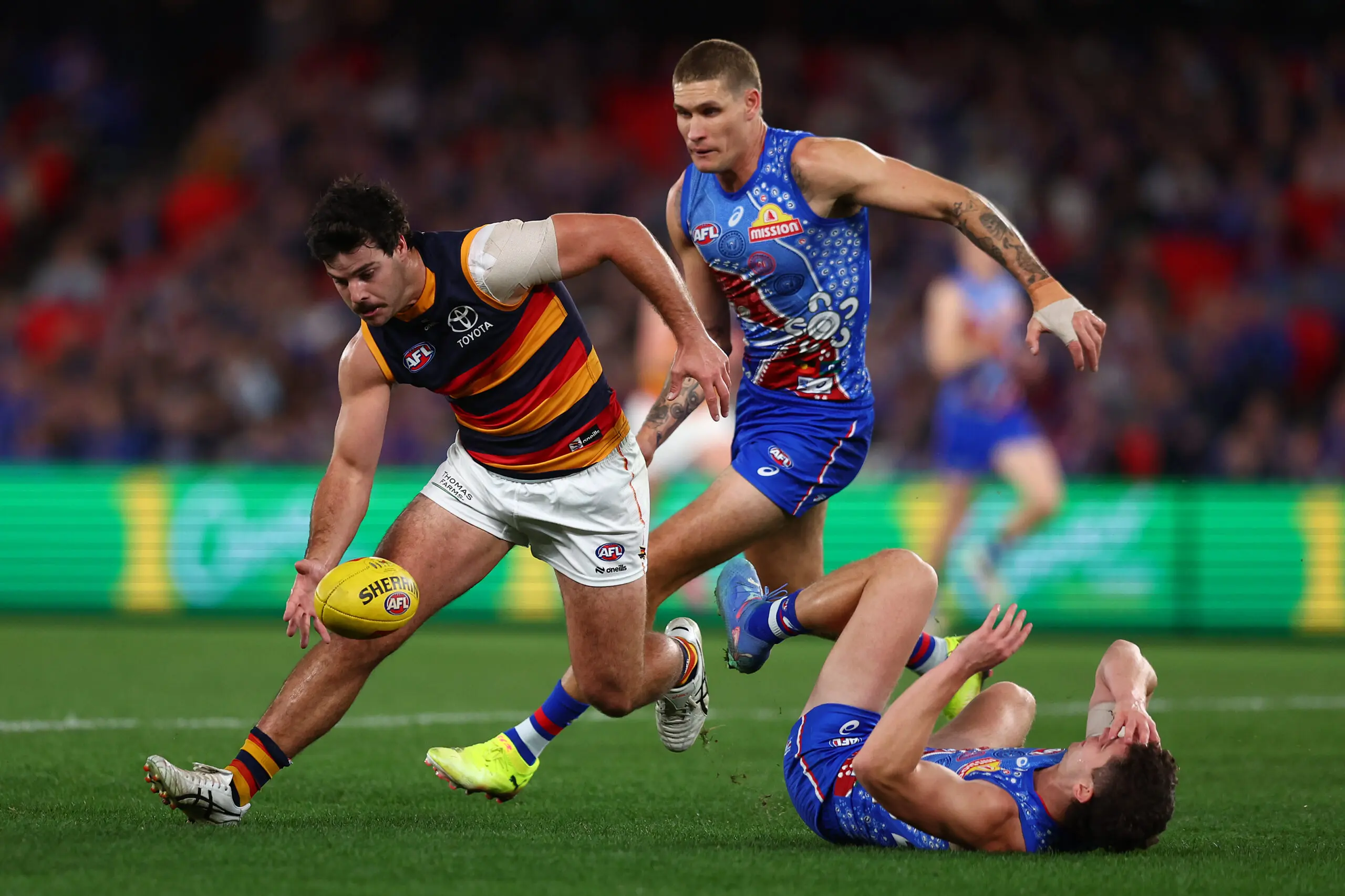 MELBOURNE, AUSTRALIA - JULY 12: Darcy Fogarty of the Crows (L) is challenged by Rory Lobb of the Bulldogs during the round 18 AFL match between Western Bulldogs and Adelaide Crows at Marvel Stadium on July 12, 2025 in Melbourne, Australia. (Photo by Graham Denholm/Getty Images)