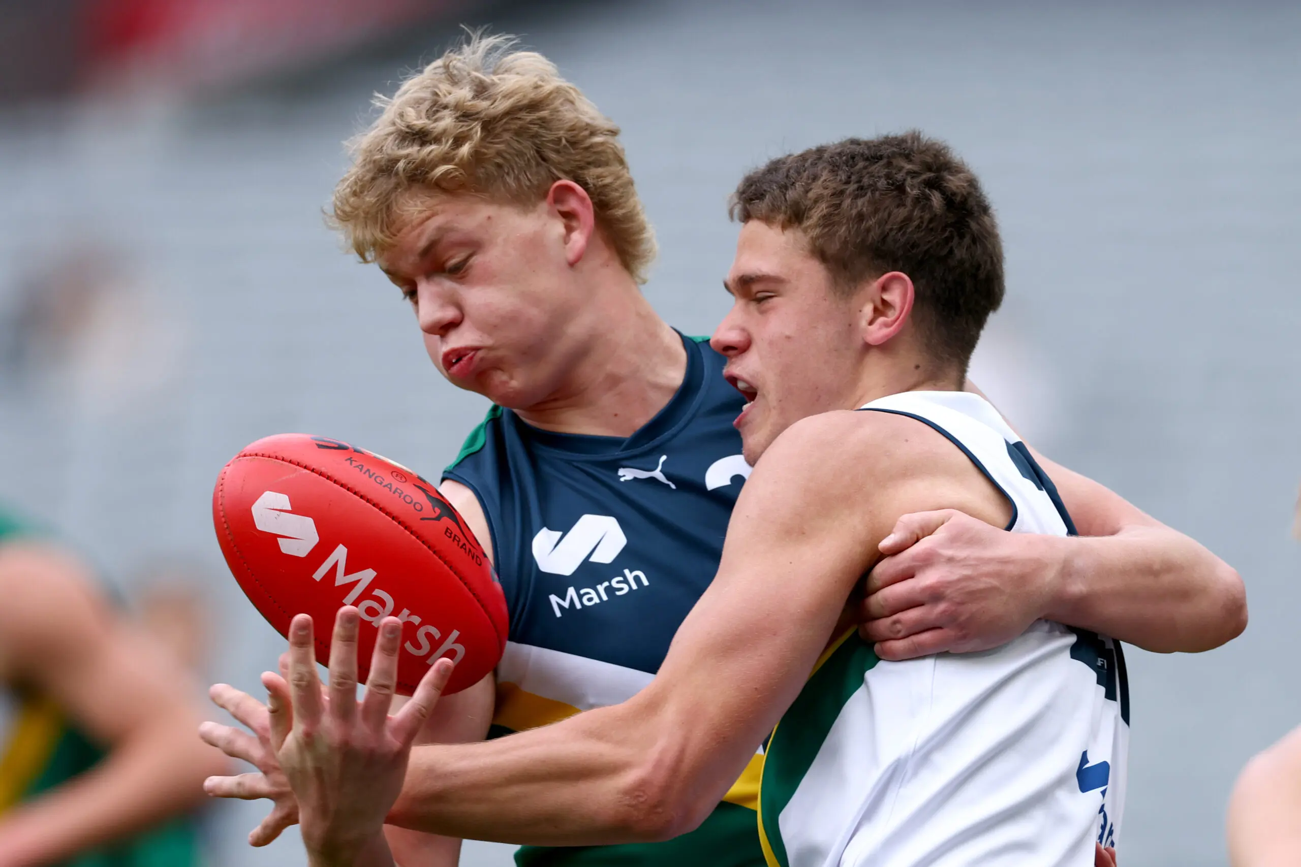 MELBOURNE, AUSTRALIA - SEPTEMBER 27: Harry Van Hattum of Team Docherty is tackled by bolhduring the Marsh AFL National Futures Boys match between Team Boak and Team Docherty at Melbourne Cricket Ground, on September 27, 2025 in Melbourne, Australia. (Photo by Josh Chadwick/AFL Photos/via Getty Images)