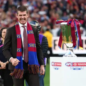 MELBOURNE, AUSTRALIA - SEPTEMBER 27: Jonathan Brown presents the Premiership Cup to Harris Andrews of the Lions, Chris Fagan, Senior Coach of the Lions and Lachie Neale of the Lions during the AFL Grand Final match between Geelong Cats and Brisbane Lions at Melbourne Cricket Ground on September 27, 2025 in Melbourne, Australia. (Photo by Daniel Pockett/AFL Photos/via Getty Images)
