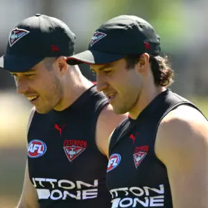 MELBOURNE, AUSTRALIA - FEBRUARY 16: Zach Merrett and Andrew McGrath of the Bombers chat during an Essendon Bombers AFL training session at The Hangar on February 16, 2026 in Melbourne, Australia. (Photo by Quinn Rooney/Getty Images)