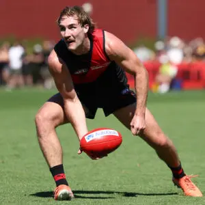 MELBOURNE, AUSTRALIA - FEBRUARY 20: Dyson Sharp of the Bombers handpasses the ball during the 2026 AFL match simulation between the Essendon Bombers and the Richmond Tigers at the NEC Hangar on February 20, 2026 in Melbourne, Australia. (Photo by James Wiltshire/AFL Photos via Getty Images)