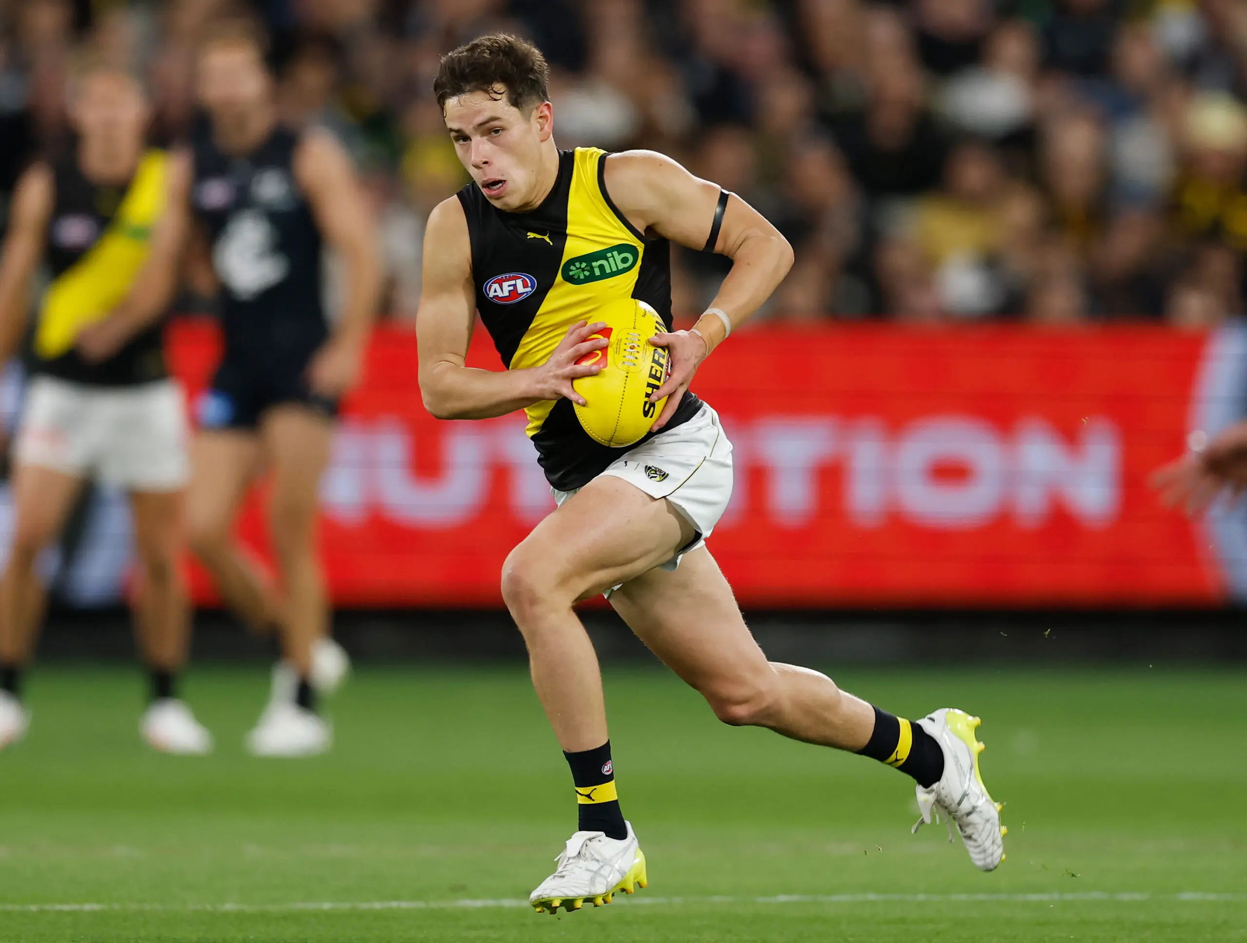 MELBOURNE, AUSTRALIA - MARCH 12: Debutant, Sam Grlj of the Tigers runs with the ball during the 2026 AFL Round 01 match between the Carlton Blues and the Richmond Tigers at the Melbourne Cricket Ground on March 12, 2026 in Melbourne, Australia. (Photo by Michael Willson/AFL Photos via Getty Images)