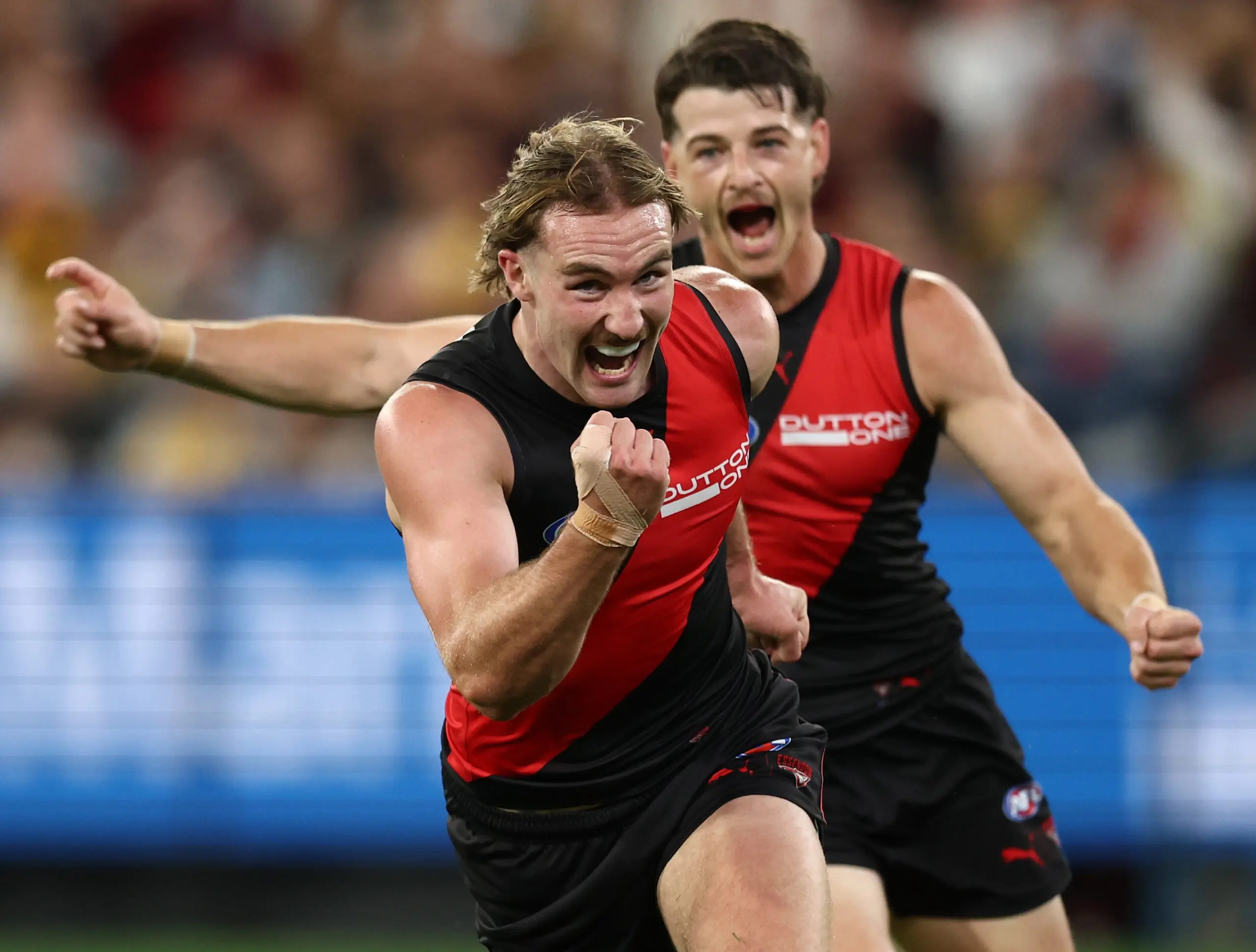 MELBOURNE, AUSTRALIA - MARCH 13: Dyson Sharp of the Bombers celebrates his first goal during the 2026 AFL Round 01 match between the Essendon Bombers and the Hawthorn Hawks at the Melbourne Cricket Ground on March 13, 2026 in Melbourne, Australia. (Photo by James Wiltshire/AFL Photos via Getty Images)